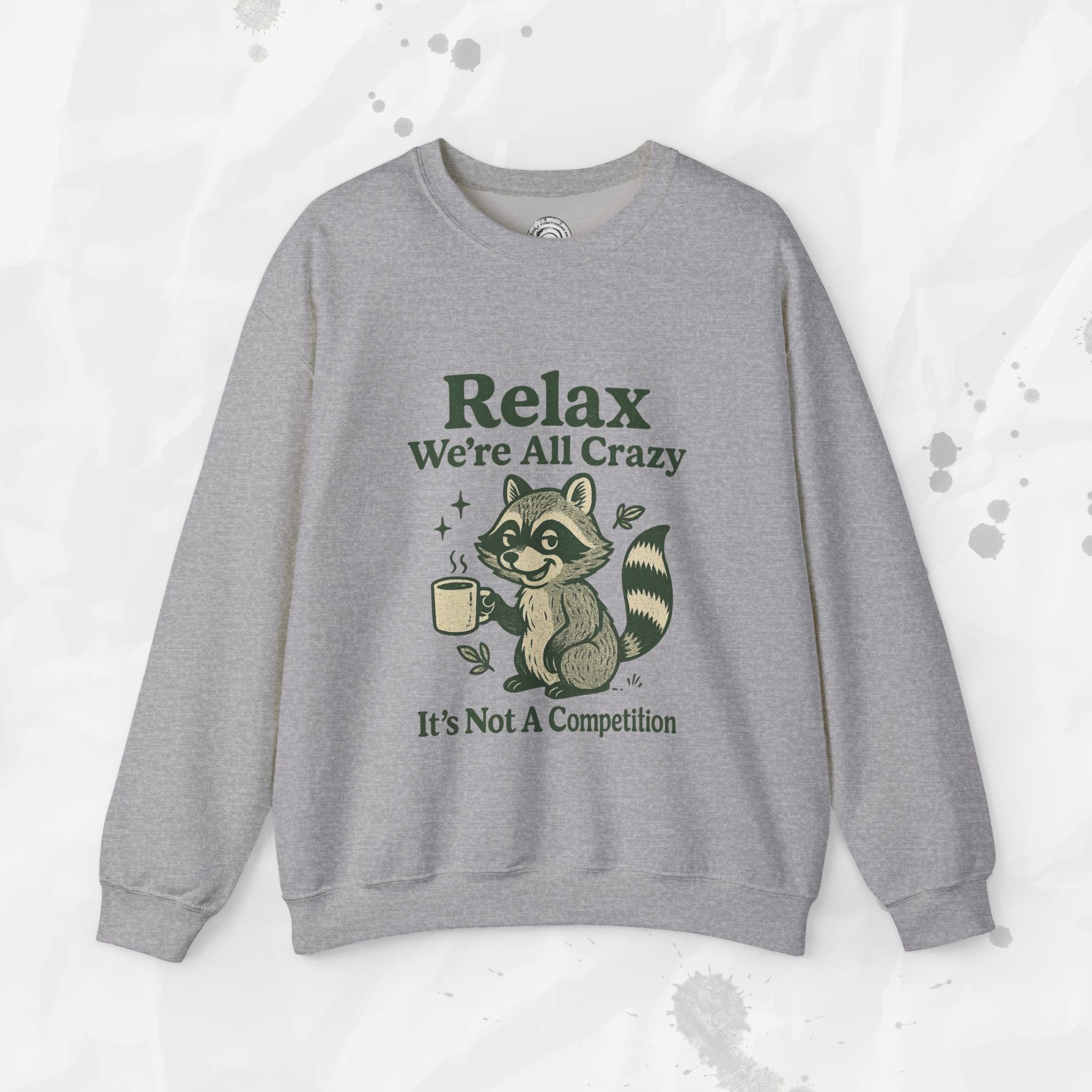 Gray sweatshirt with raccoon graphic and text on a light gray background