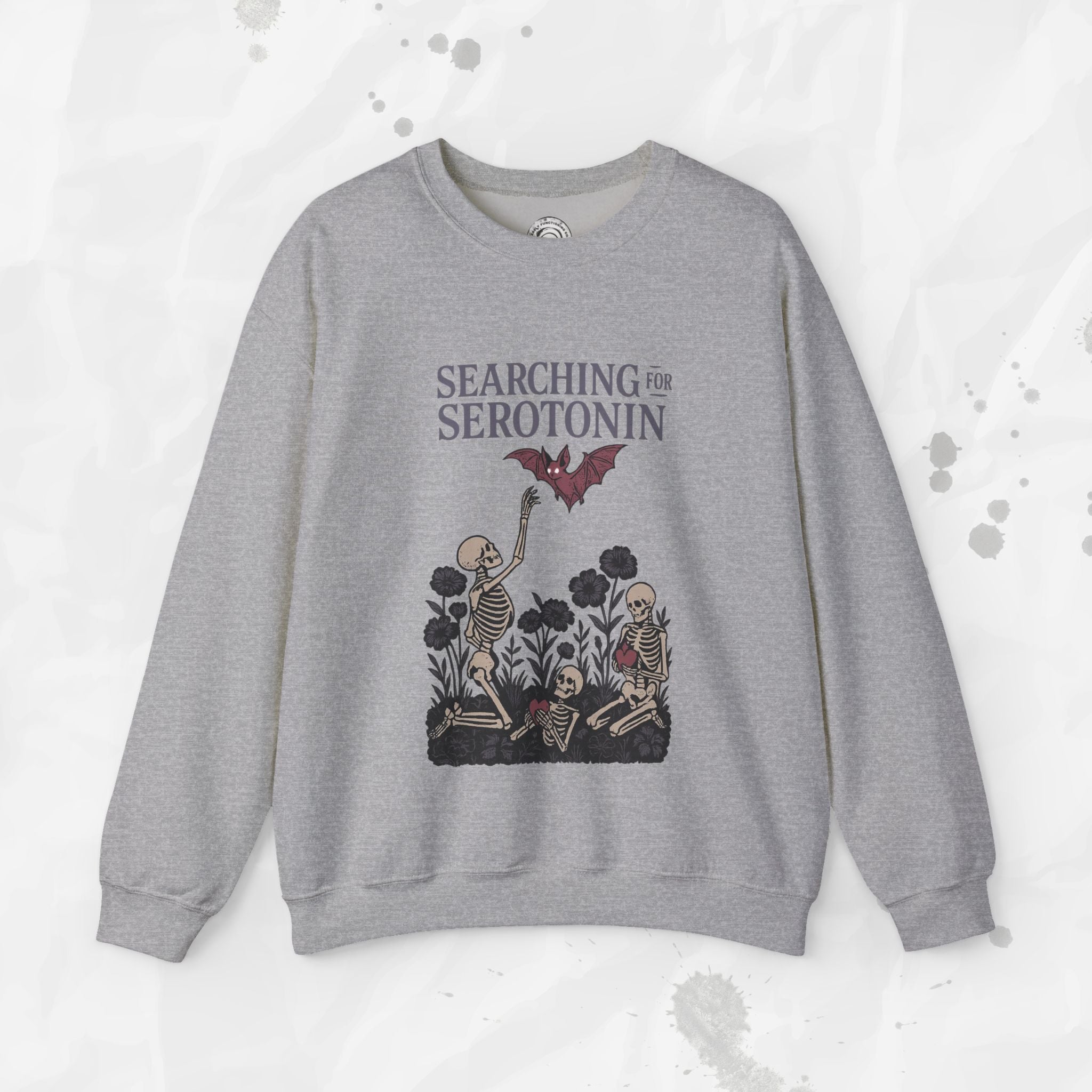Gray sweatshirt with skeleton design and text 'Searching for Serotonin' on a light gray background