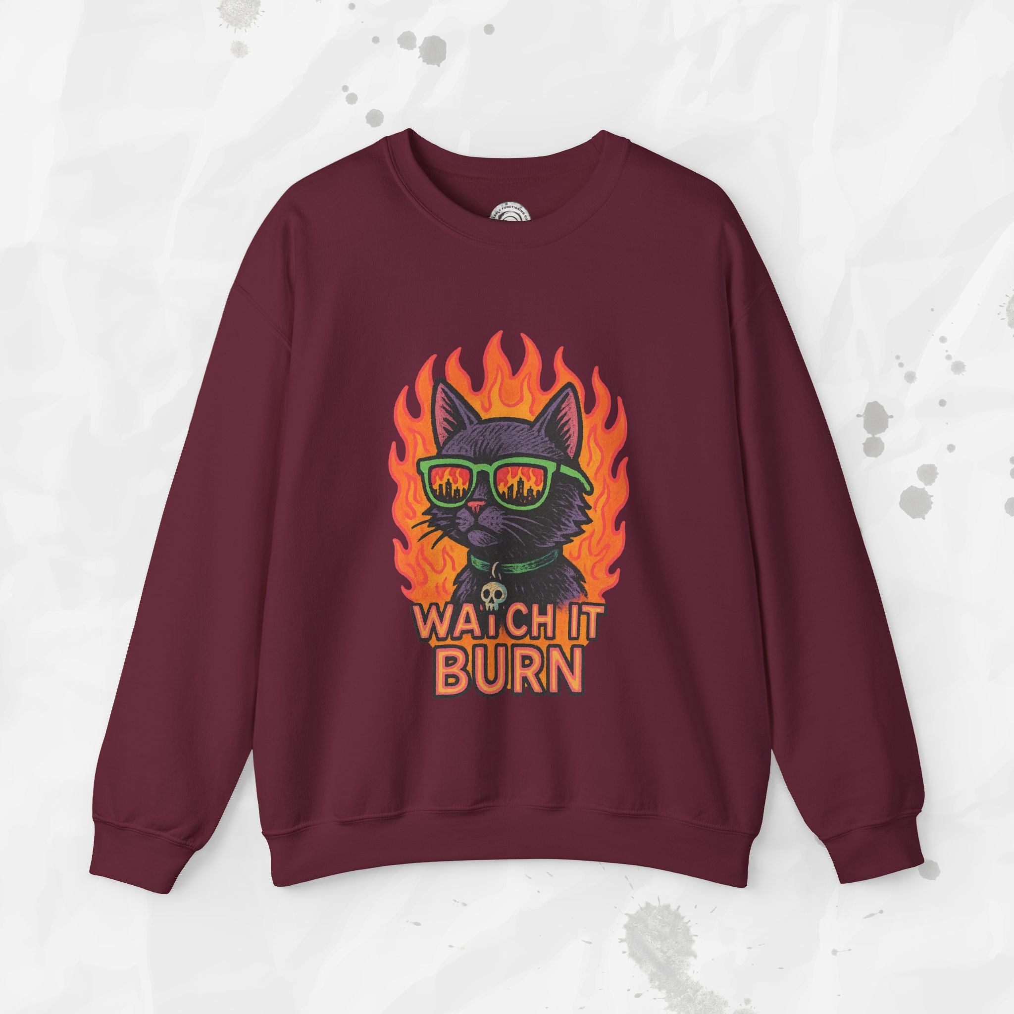 Maroon sweatshirt with a graphic of a cat in flames and 'Watch It Burn' text on a light gray background.