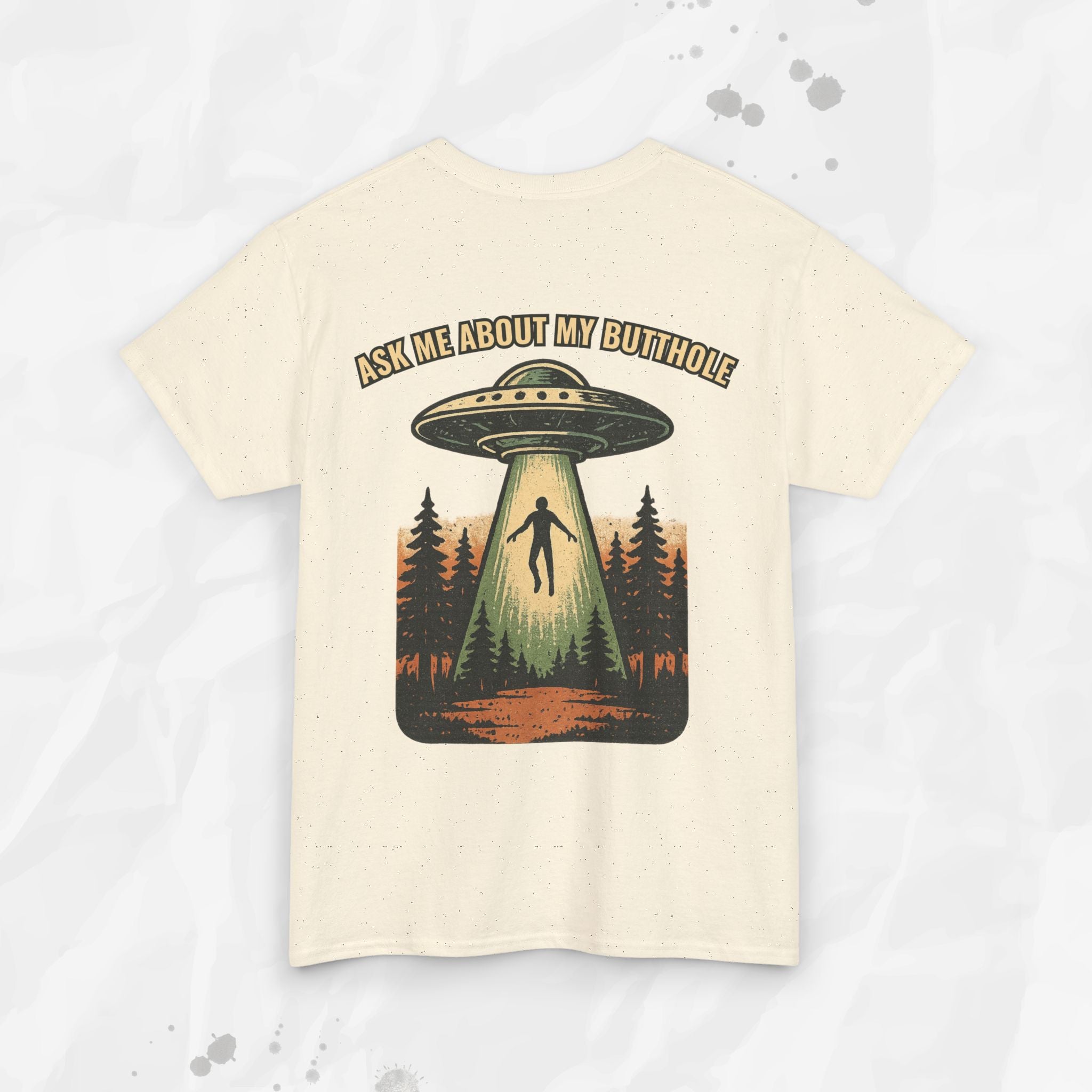 Beige t-shirt with UFO graphic and text 'Ask me about my butthole' on a light gray background
