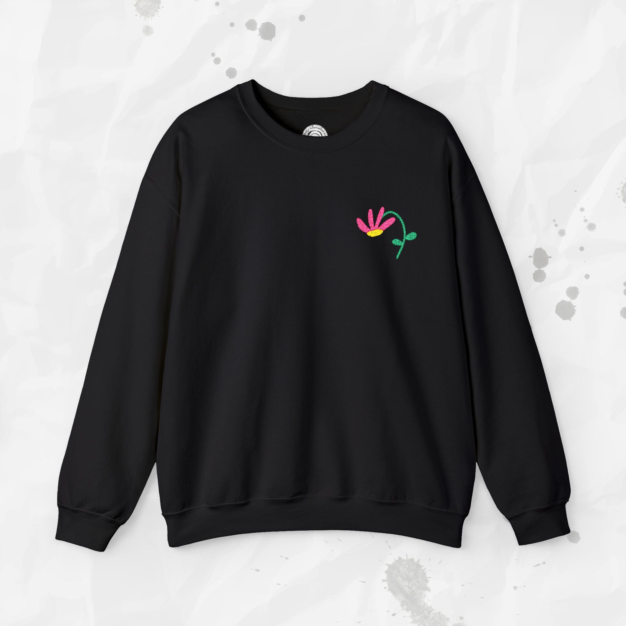 Black sweatshirt with a colorful flower design on a light gray background