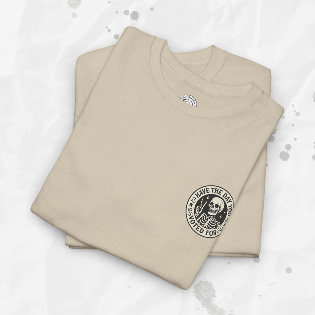 Folded beige t-shirt with a black graphic design on a light gray background