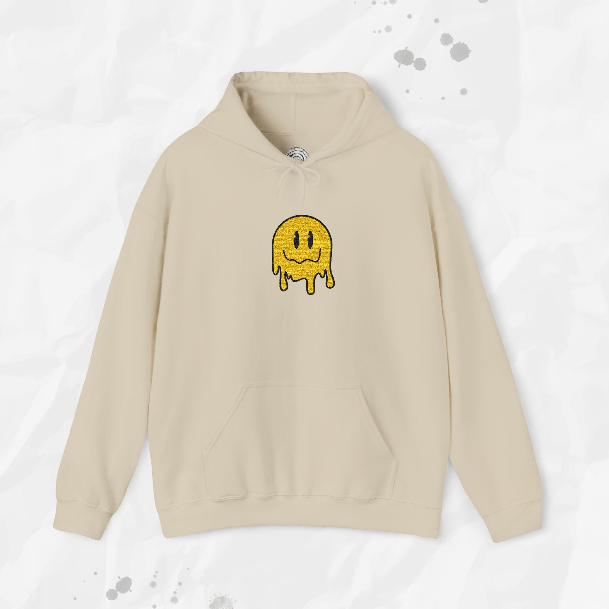 Beige hoodie with a yellow smiley face design on a light gray background